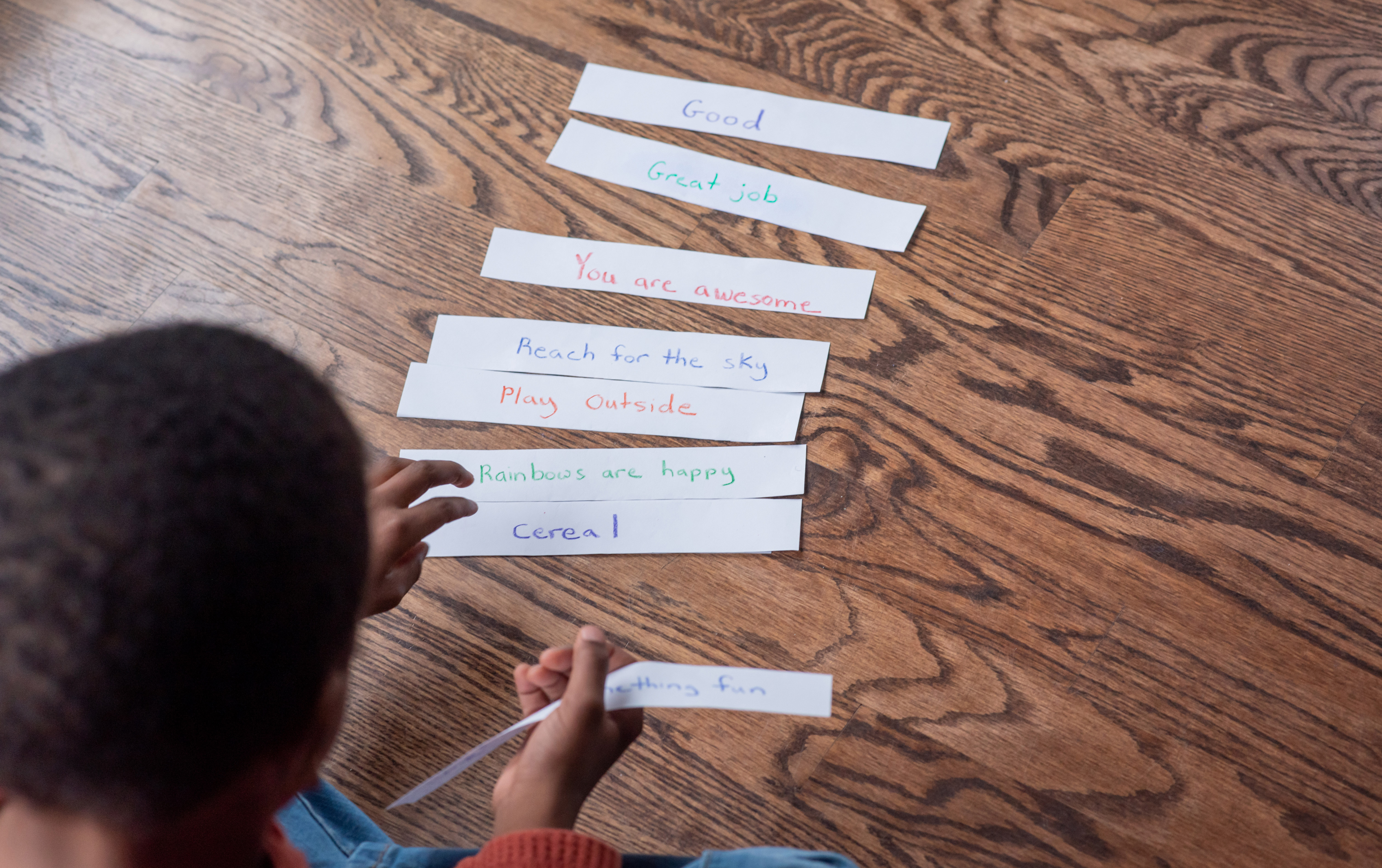 Young child creating a poetry stack.
