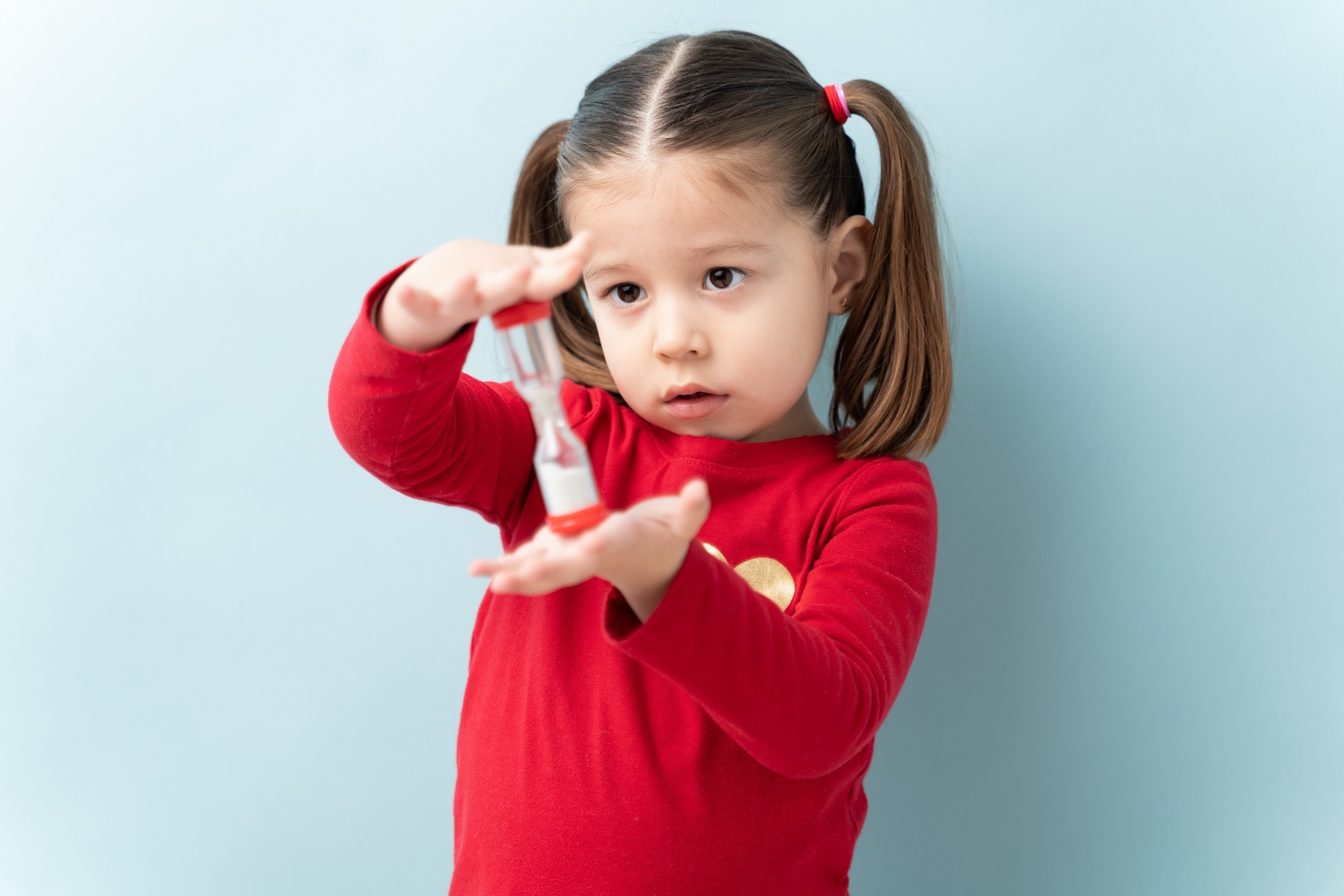 Girl holding a sand timer.