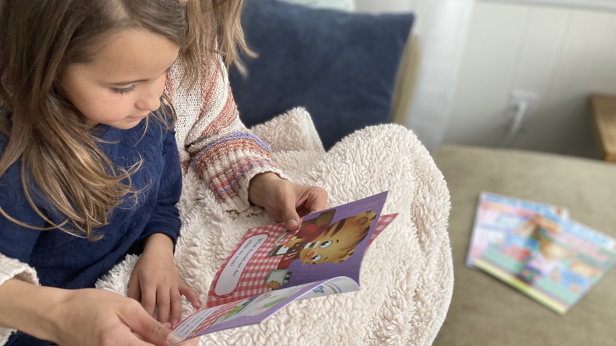 Child and parent reading together