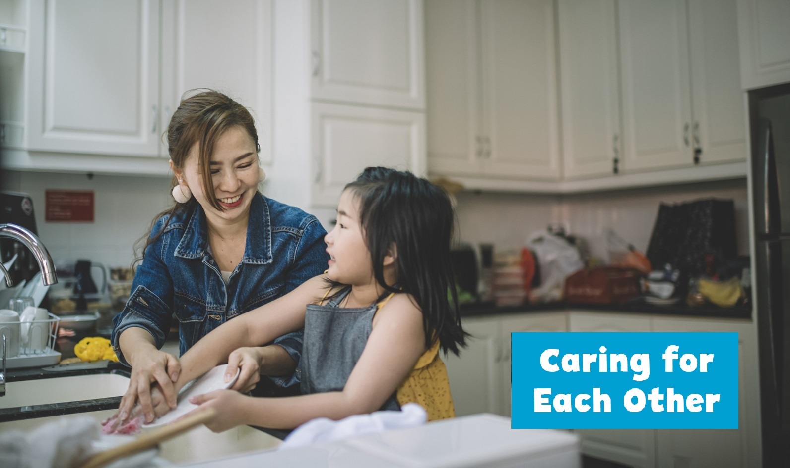Image of parent and child washing dishes together.